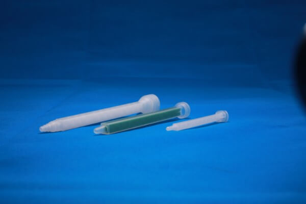 Different sized nozzles for use with manual application guns for adhesives