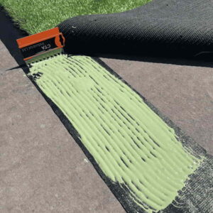 Grass glue being spread onto a liner